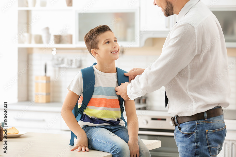 Man helping his son get ready for school Man helping his son get ready for school