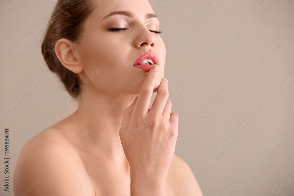 Portrait of beautiful young woman with soft skin after applying cream on color background Portrait of beautiful young woman with soft skin after applying cream on color background