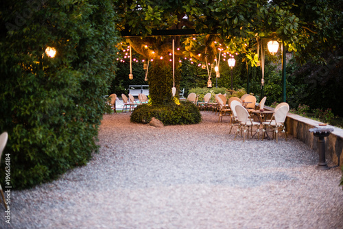 villa garden with large magnolia tree with many lanterns hanging from its branches