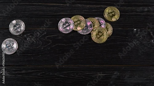 Golden bitcoins. Coins of cryptocurrency on black table. photo