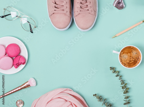 Cute feminine accessories and coffee on the pastel background, top view