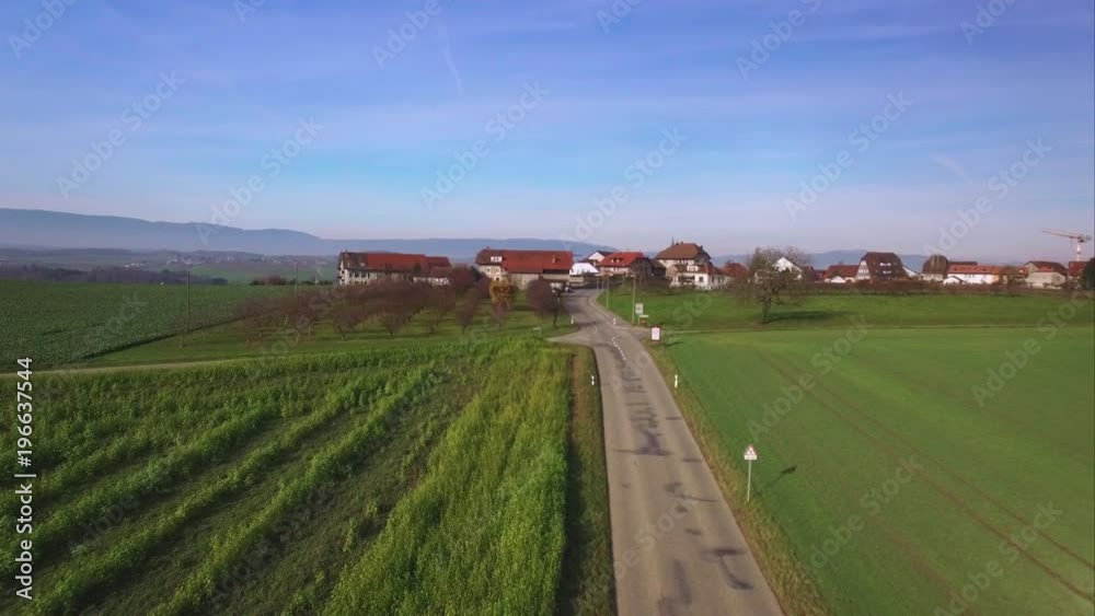 4K Swiss village drone shot. Discovering a lovely town surrounded by fields and forests - Switzerland aerial 4K Swiss village drone shot. Discovering a lovely town surrounded by fields and forests - Switzerland aerial