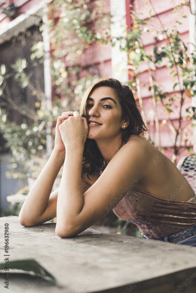 Portrait of smiling young woman leaning on table Portrait of smiling young woman leaning on table