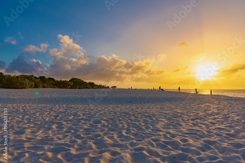 Sailboats at sunset on the beach of the Caribbean island of Aruba © DD25