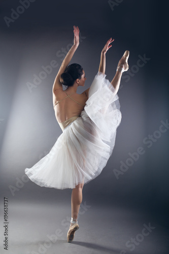 Beautiful slim woman ballet dancer in studio