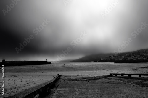Coastal scene with man and child watching the storm approaching