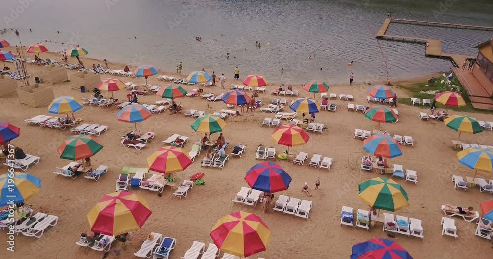 Flight over a bright beach with colored bungalows Flight over a bright beach with colored bungalows