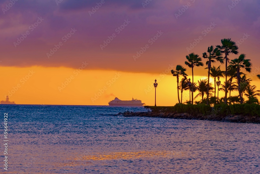 colorful sunset with boats in the ocean in the caribbean sea Island of Aruba