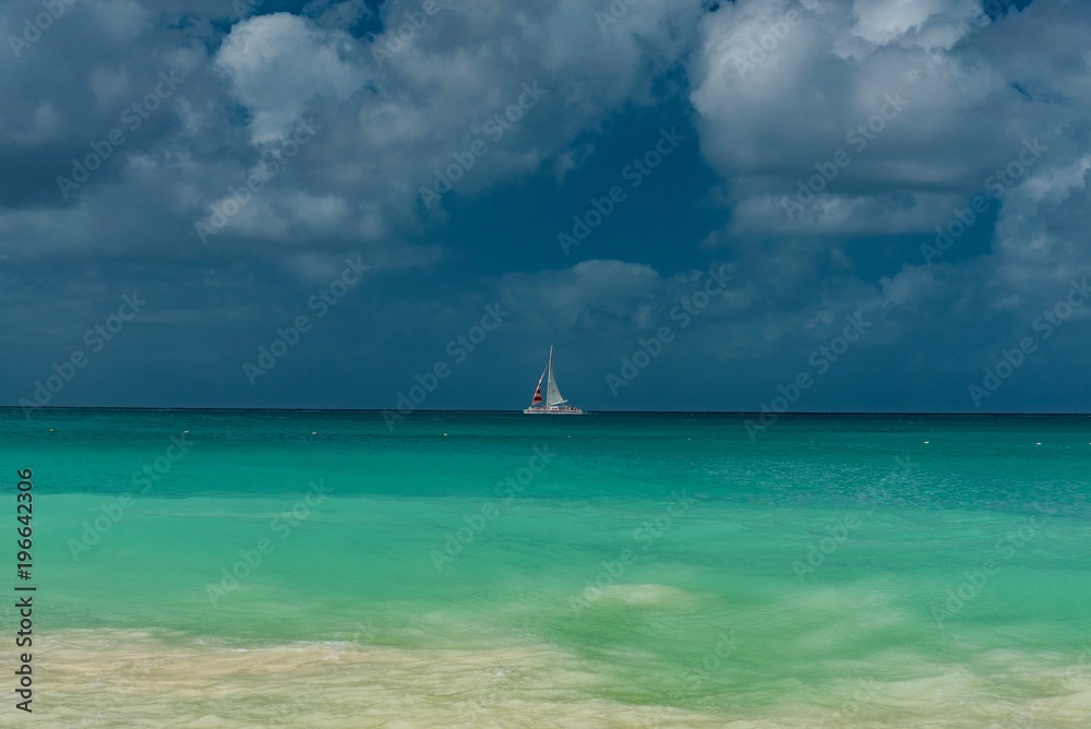 white beach with with sailboats in the ocean in the Caribbean sea Island of Aruba