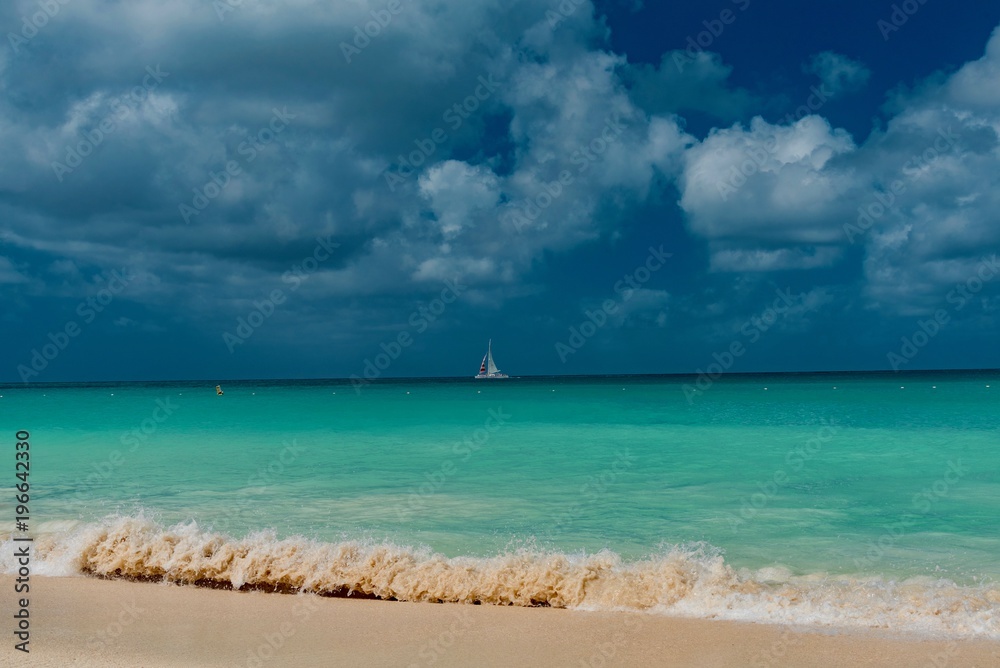 white beach with with sailboats in the ocean in the Caribbean sea Island of Aruba