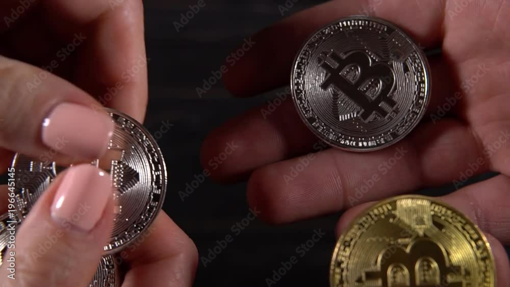 Woman gives the bitcoin to man from hands to hands