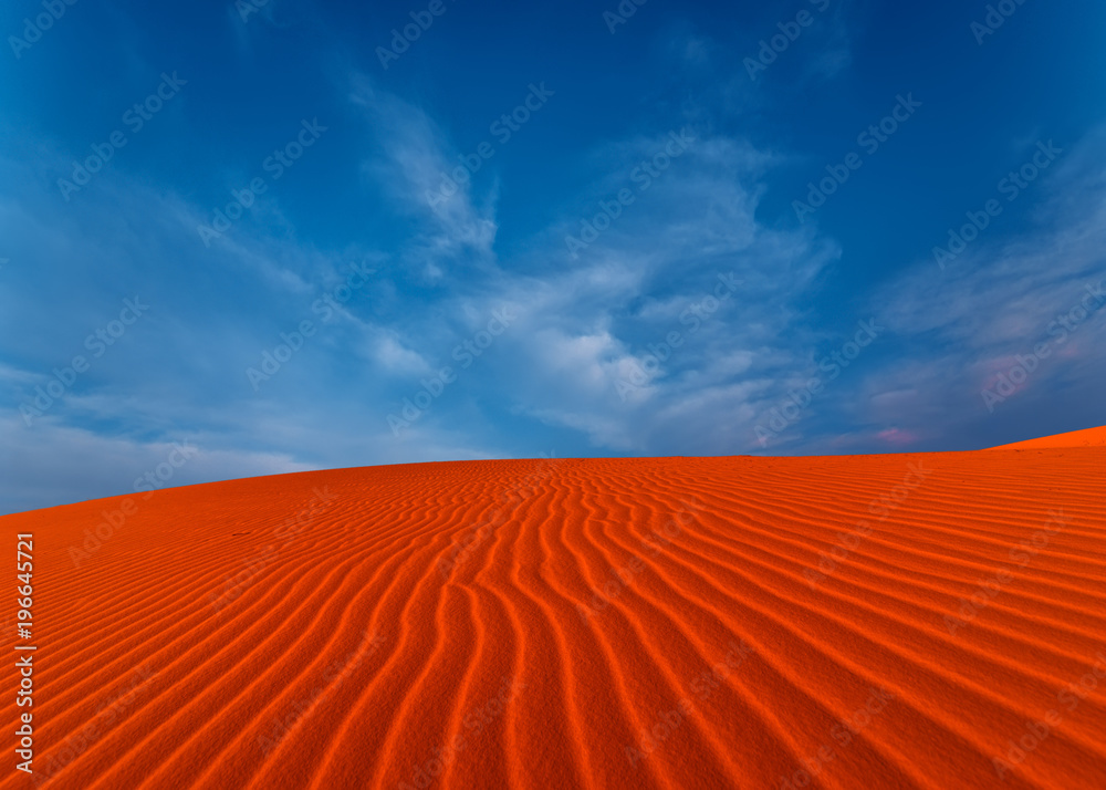 Naklejka premium Stunning view of rippled sand dunes under amazing blue sky at drought desert landscape. Global warming concept.