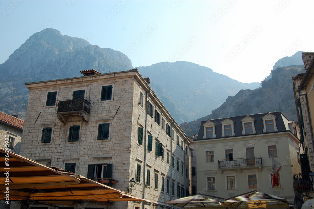 The architecture of the old town of Kotor and mountains in the background.