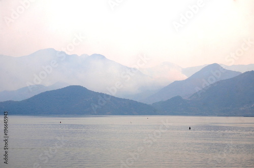 Skadar lake in the evening colors on the background of the mountains.