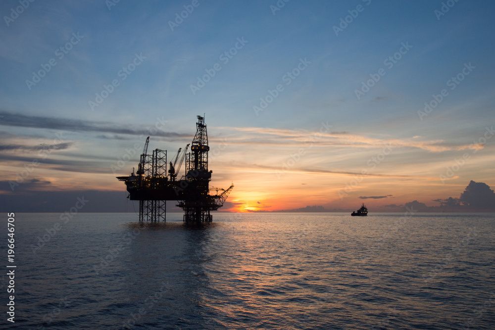 Silhouette of an oil and gas rig or platform during sunset.