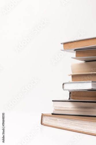 Partial view of stack of different books isolated on white