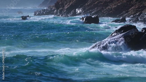 Rough sea ocean surf - waves breaking on the rocks. Splash of water - natural power
