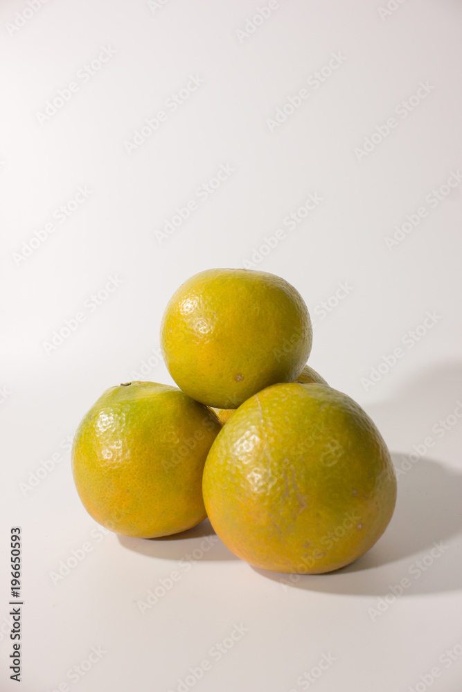 Vertical group of ripe orange on white background. Vertical group of ripe orange on white background.