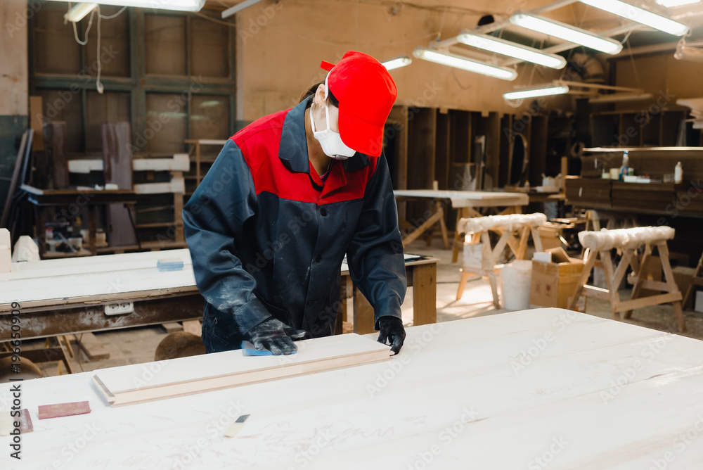 the worker grinds the door parts the worker grinds the door parts