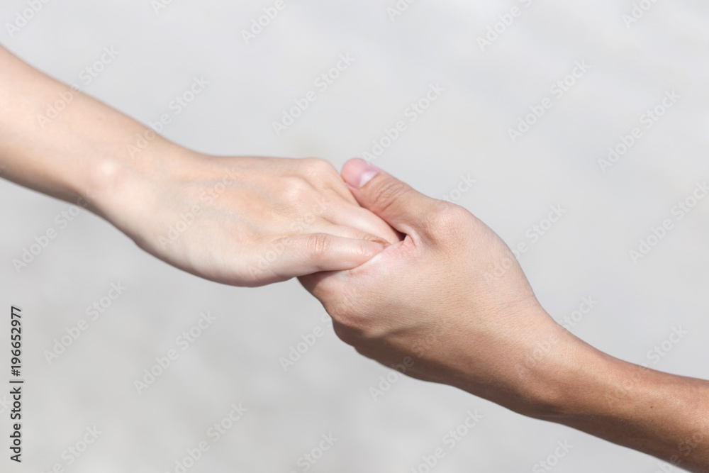 closeup of couple hold hands closeup of couple hold hands