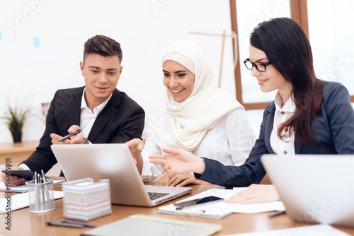 Photography The Arab woman in hijab works in the office together with her colleagues