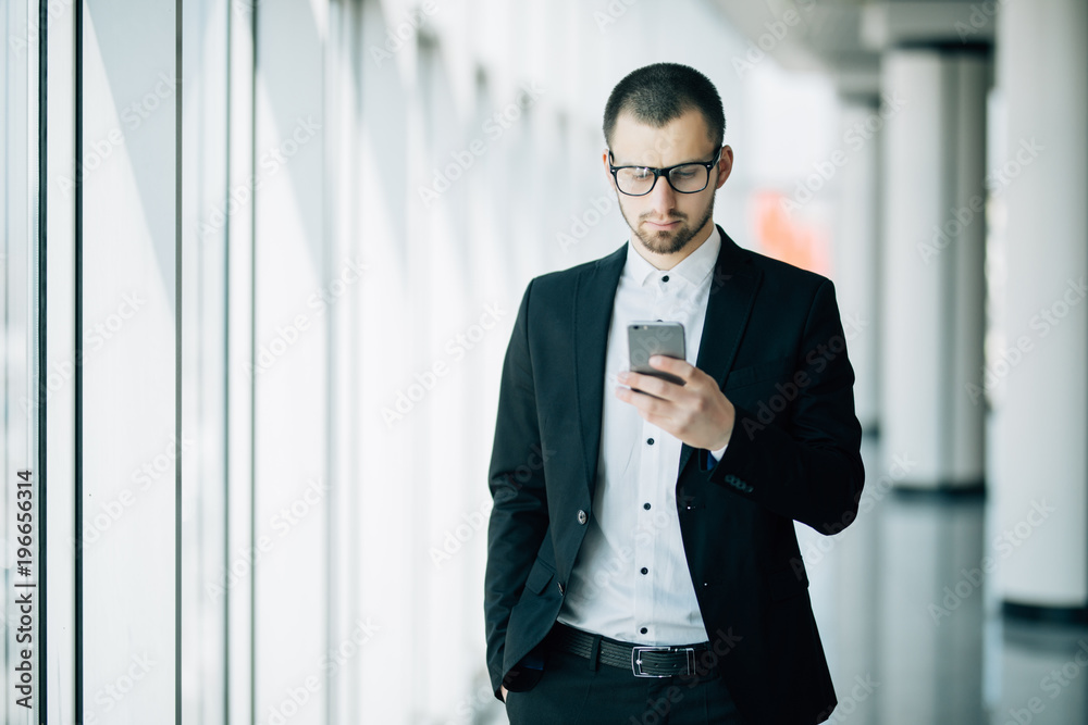 Business man use on mobile phone call standing in front panoramic window Business man use on mobile phone call standing in front panoramic window