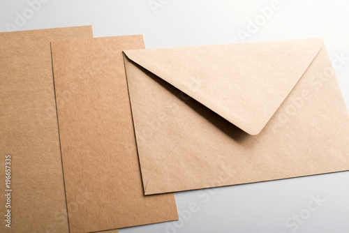 Cardboards and brown envelope on gray background. Mockup. © Freestocker