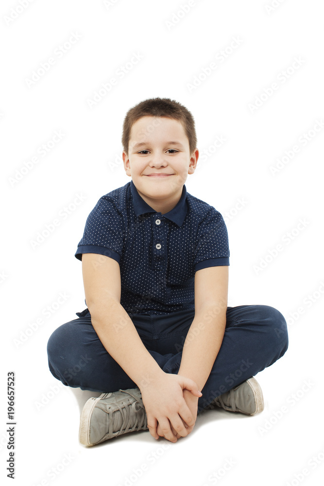 Portrait of a cute little boy sitting on the floor. Isolated on white background Portrait of a cute little boy sitting on the floor. Isolated on white background