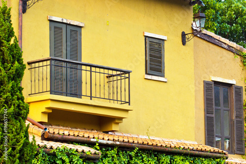 Window balcony in the yellow wall