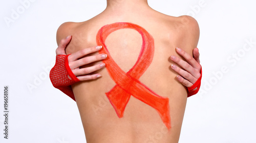 Canvas Print A young semi nude girl has her back turned to the camera