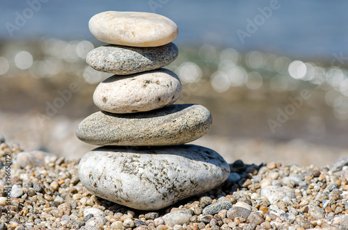 pyramid of colorful pebbles . Rock Zen in the background of the sea. Concept of harmony and balance.