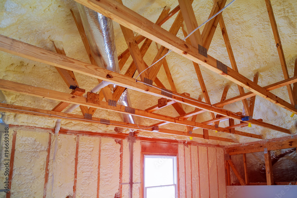 Obraz premium New home construction with installation of heating system on the roof of the pipe