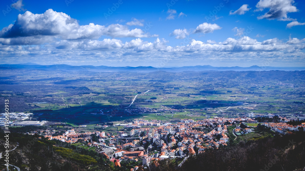 View of small Portuguese town Covilha and district Castelo Branco. View from mountains Serra fa Estrella. Summer day.