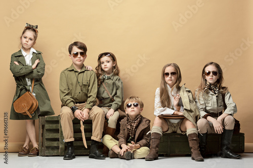 The group of beautiful girls and boys on a pastel background photo