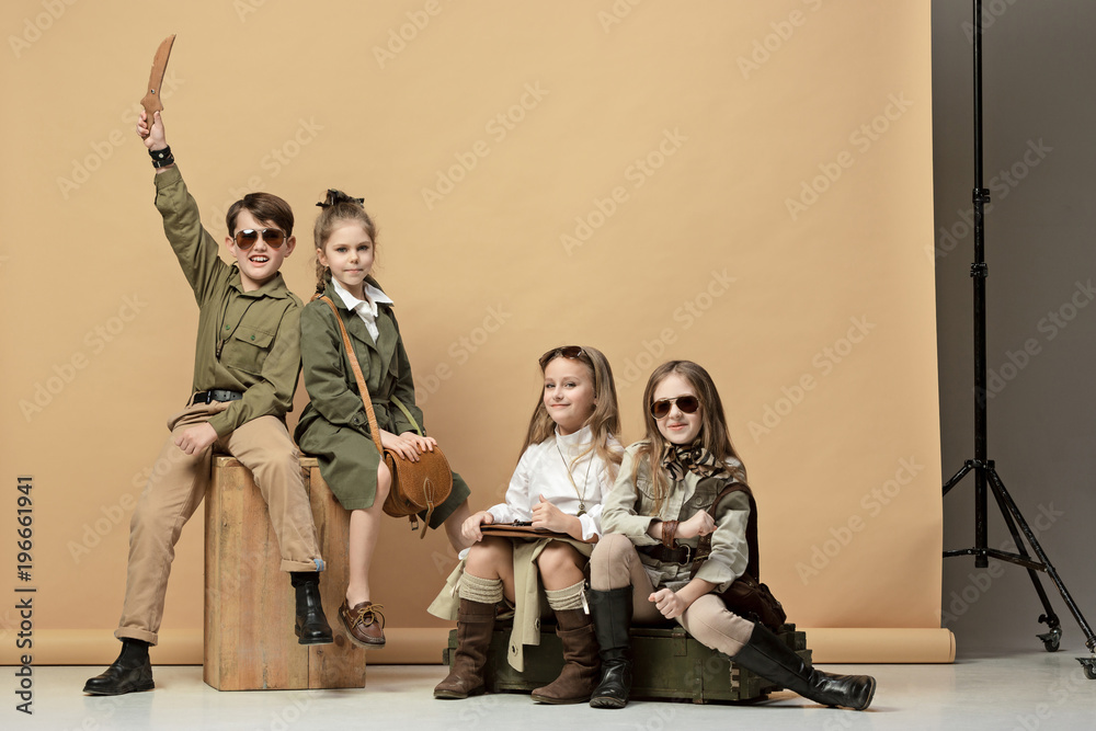 Fototapeta premium The group of beautiful girls and boys on a pastel background