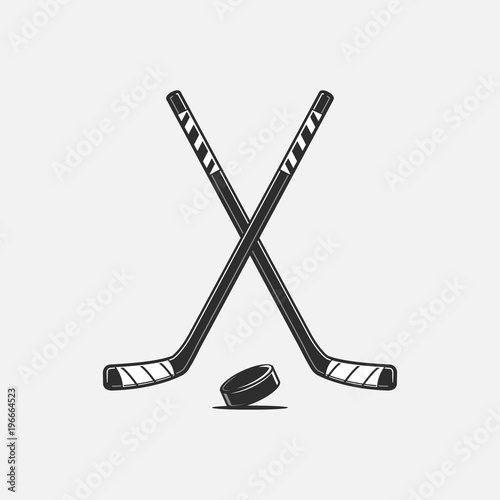 Crossed hockey sticks and puck vector illustration photo