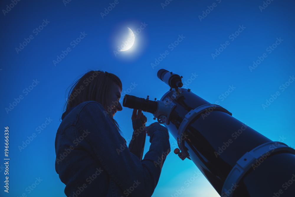 Fototapeta premium Silhouette of a girl and telescope with Moon on the sky.