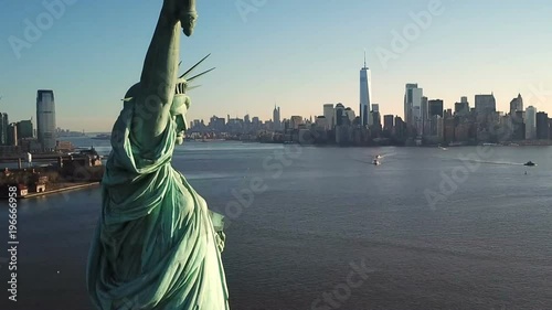 Statue of Liberty aerial pulling back from close up with Manhattan skyline in background in New York City NYC in 1080 HD photo