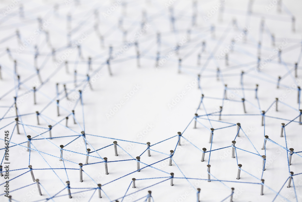 A large grid of pins connected with string. Communication, technology, network concept A large grid of pins connected with string. Communication, technology, network concept