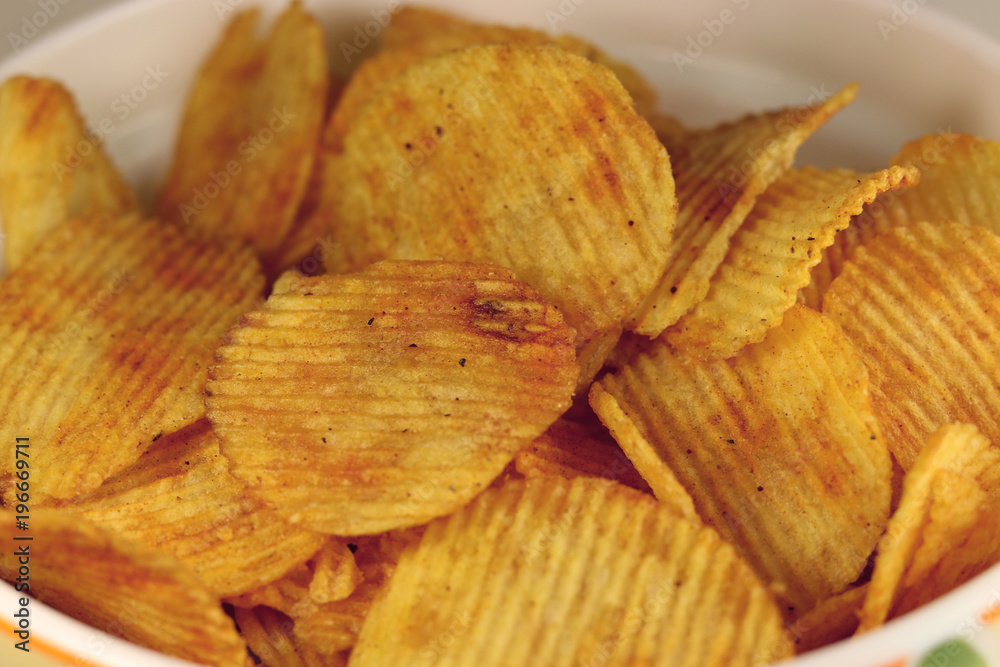 Tasty corrugated potato chips, unhealthy food.