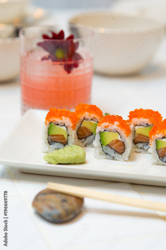 Tray of maki sushi with avocado, salmon and caviar