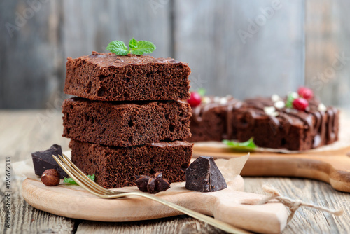 Obraz na płótnie Chocolate brownie cake, dessert with nuts on wooden background.