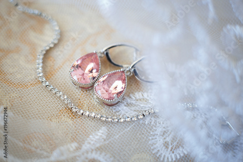 Pink crystal earrings for bride with white necklace