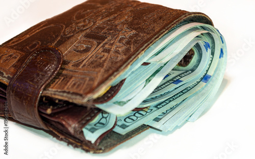 Wallet full of 100 us dollar bills in cash. photo