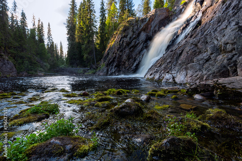 Beautiful waterfall with stones on foreground