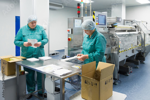 Pharmaceutical factory workers in sterile environment