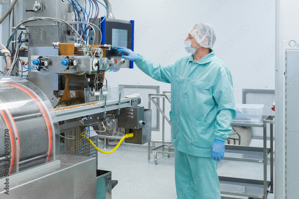 Pharmacy industry factory man worker in protective clothing in sterile working conditions Pharmacy industry factory man worker in protective clothing in sterile working conditions