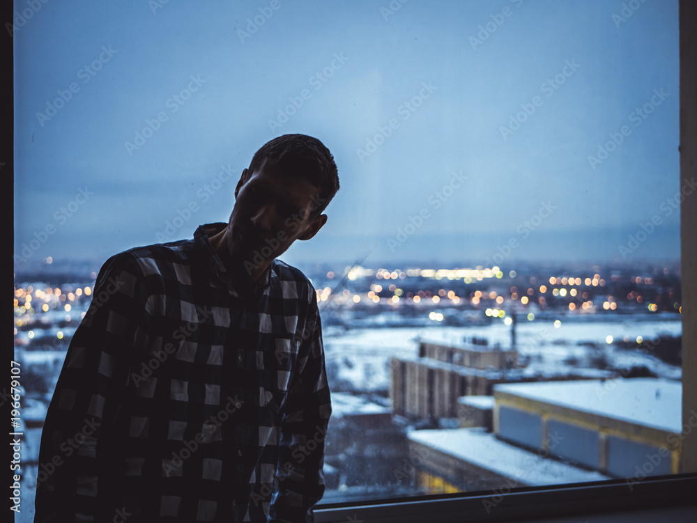 silhouette of man standing near the window