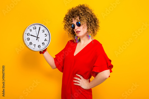 Attractive woman with short curly hair with clocks photo