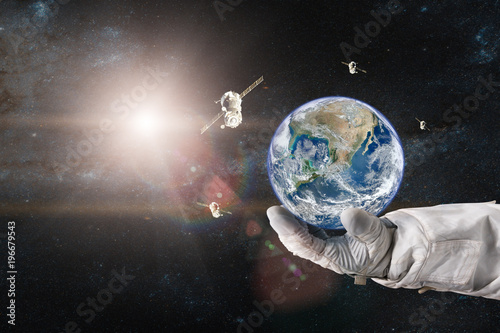 Earth with a spacecraft launched into space in the hands of astronaut. Elements of this image furnished by NASA.